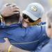 Former Michigan football players Kevin Koger hugs Mike Martin on the sideline at Michigan Stadium. Melanie Maxwell I AnnArbor.com
